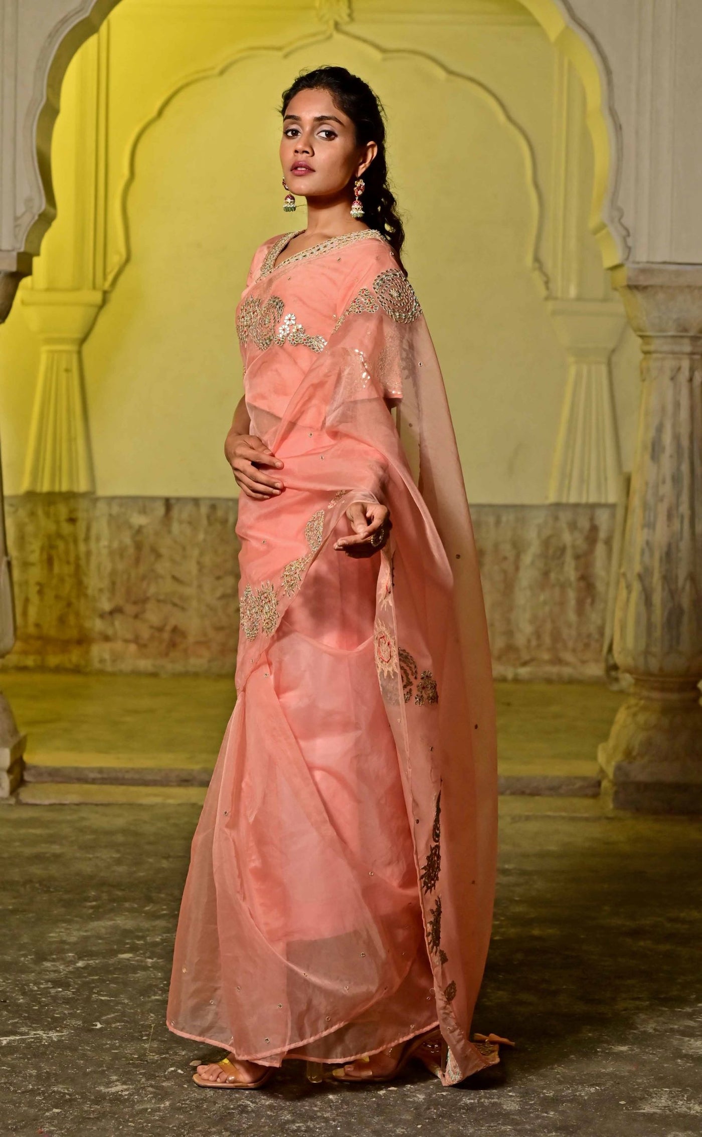 Women's peach organza saree with intricate embroidery for a luxurious look